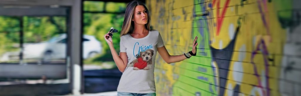 Colorful graffiti art on a wall with a woman in casual attire touching the mural.