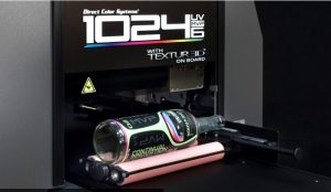 Vibrant colored graphics being printed onto a glass bottle using a digital printing machine with LED UV technology for customized branding.