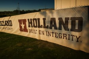 Premium outdoor banner featuring the Hollind logo, slogan "Built on Integrity," and vibrant graphics; ideal for events, promotions, and branding.