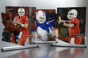Colorful sports-themed acrylic awards featuring football players in action, showcasing custom engraving options for MVP and award titles, perfect for recognizing athletic achievements and commemorations.