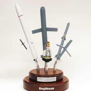 Aerospace model rockets and missiles displayed on a wooden base, representing engineering and innovation.