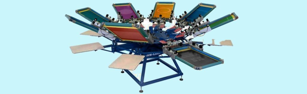 Colorful multi-station screen printing press used for designing custom signs, banners, and apparel. High-quality printing equipment ideal for producing professional promotional materials.