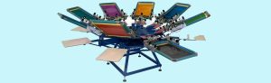 Colorful multi-station screen printing press used for designing custom signs, banners, and apparel. High-quality printing equipment ideal for producing professional promotional materials.