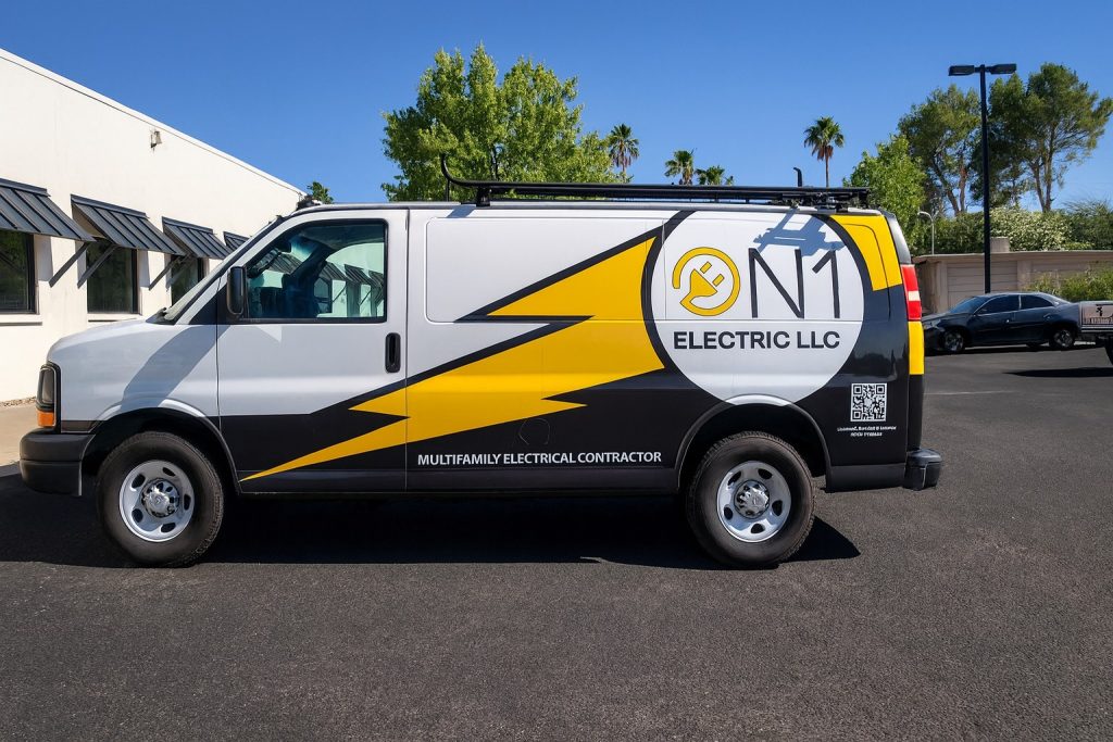 Electric van with bold yellow and black lightning bolt graphics for N1 Electric LLC, highlighting electrical services and branding.