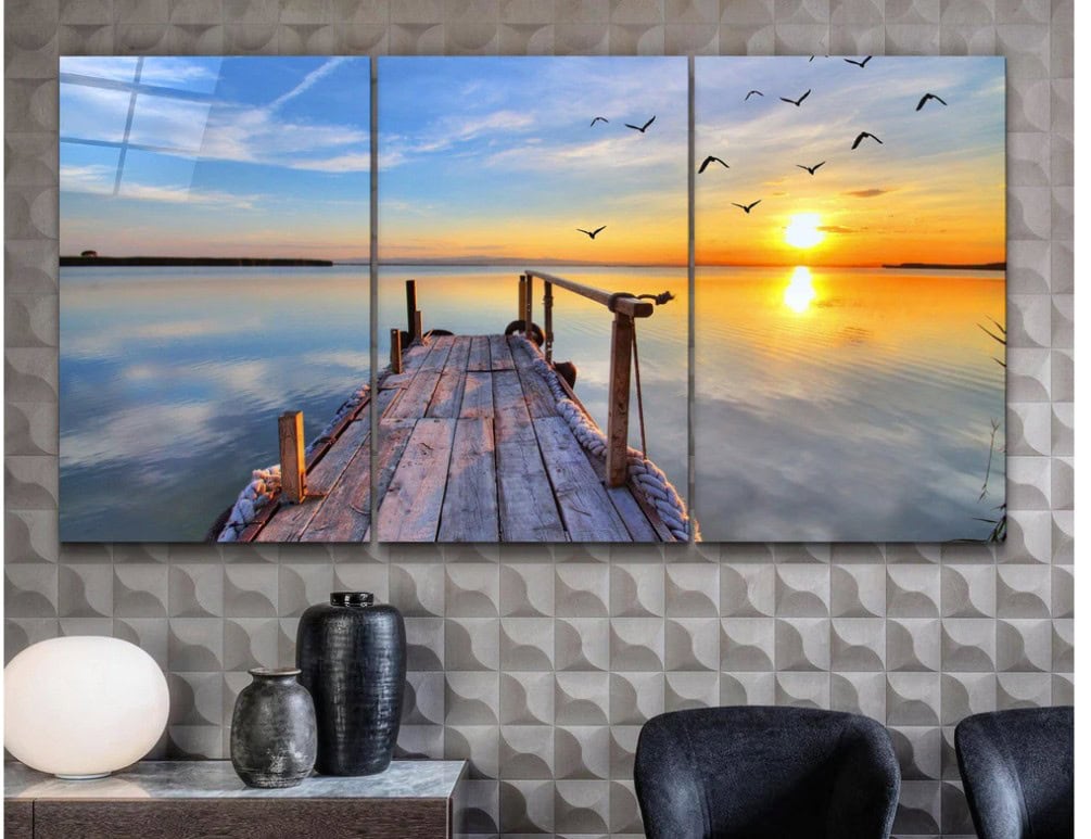 Beautiful three-panel wall art of a serene lakeside at sunset with a wooden dock and flying birds, perfect for enhancing home or office decor.