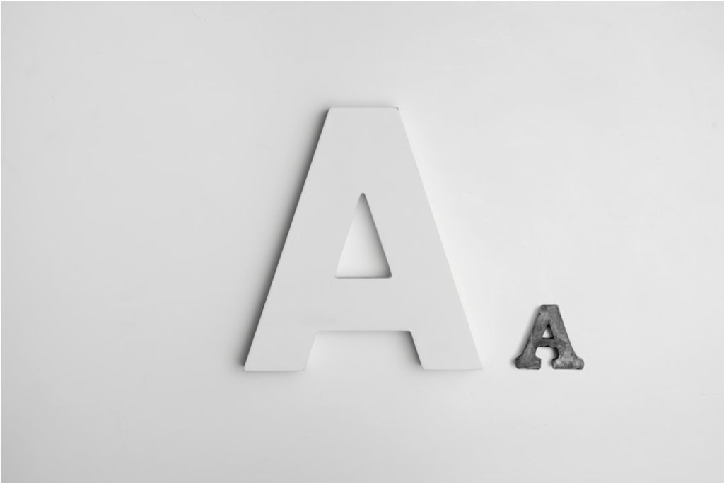 Aluminum letter "A" sign with a smaller concrete "A" letter on a white background.