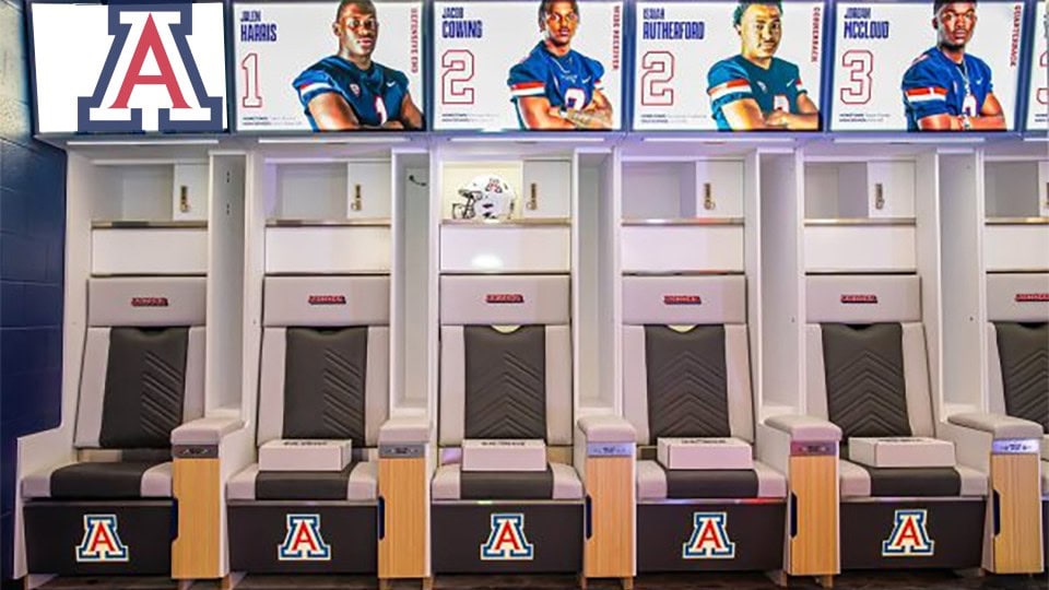 ARIZONA WILDCATS football lockers with team logos and helmets display in a sports facility.