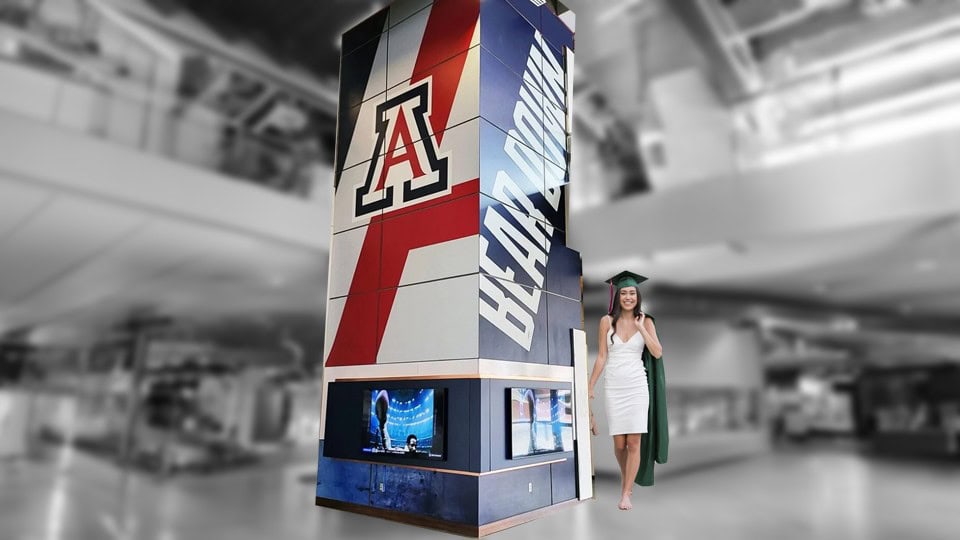 Arizona Wildcats graduation display at Graphic Impact featuring custom signs and banners for a celebratory event.