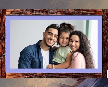 Vivid family portrait inside a custom wooden photo frame, showcasing personalized signs and promotional materials by Graphic Impact.