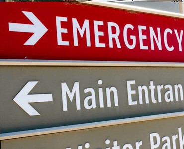 Bright red emergency exit sign with white text and arrow for clear directional guidance.