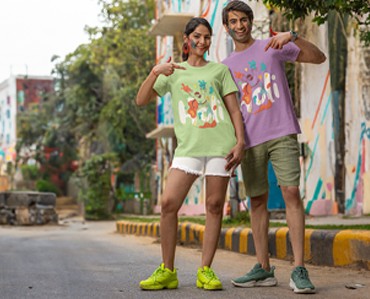 Vibrant custom t-shirts featuring colorful designs worn by a smiling young couple outdoors on a city street.
