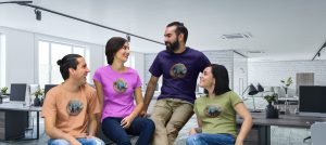 Bitcoin-themed apparel worn by diverse coworkers in modern office setting, showcasing custom t-shirts with Bitcoin logo, highlighting branding, team spirit, and promotional merchandise.