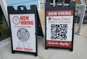 Attention-grabbing "Now Hiring" sandwich board signs for local businesses seeking to attract applicants with QR codes for easy application access. Perfect for storefront advertising and recruitment efforts.