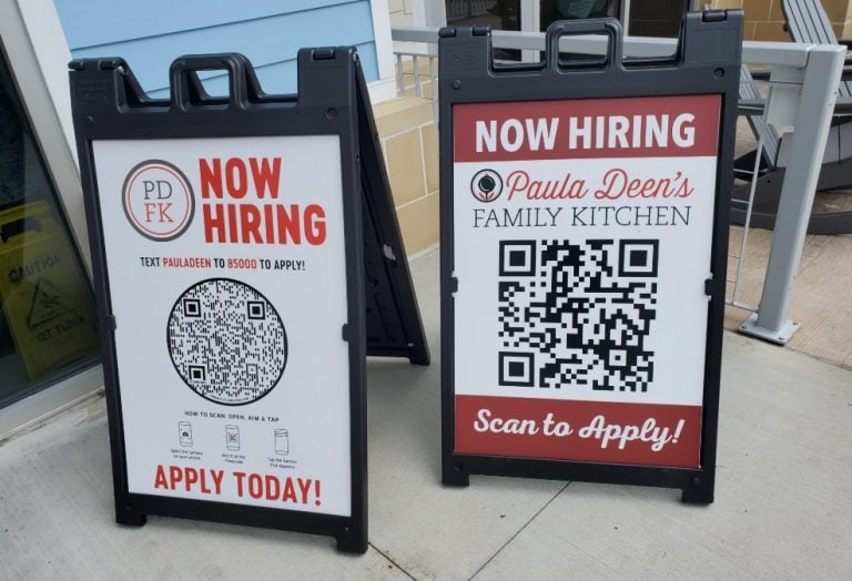 Attention-grabbing "Now Hiring" sandwich board signs for local businesses seeking to attract applicants with QR codes for easy application access. Perfect for storefront advertising and recruitment efforts.