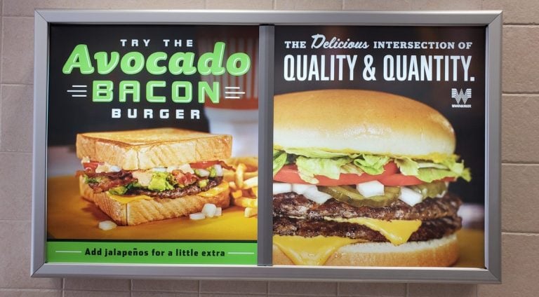 Avocado bacon burger sign, showcasing delicious sandwiches with fresh ingredients, promoting quality and quantity, ideal for restaurant advertising and menu boards.