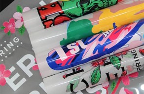 Brightly colored printed banners with graphic designs and vibrant patterns for advertising and special events. Perfect for promotional signage, custom apparel, and decorative purposes to enhance visibility and branding.